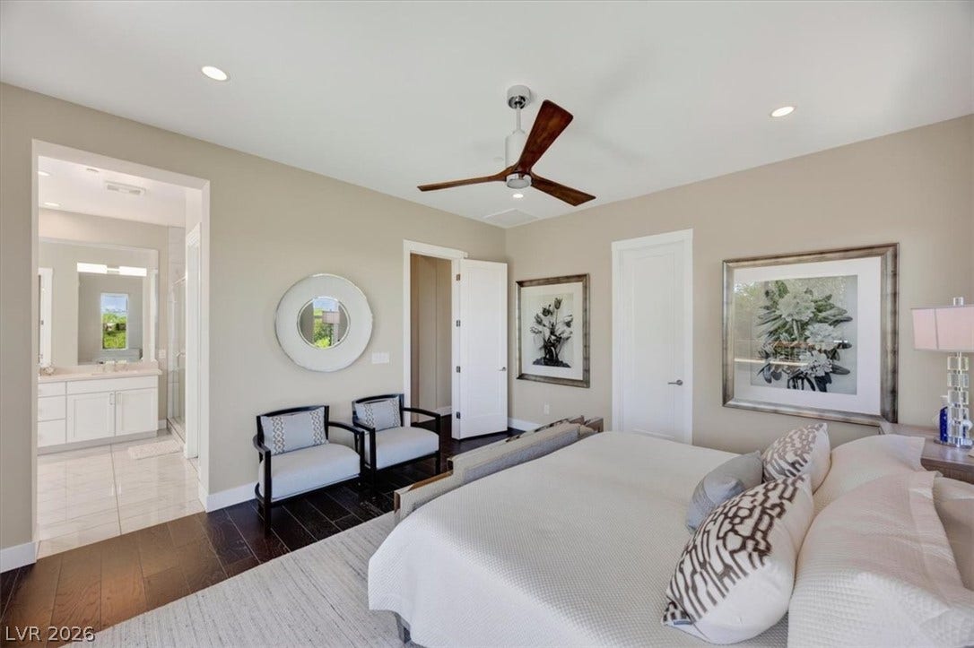 11280 Granite Ridge Drive, #1048, Las Vegas, NV 89135 Rich hardwood flooring anchors this peaceful bedroom featuring an adjacent private bath.