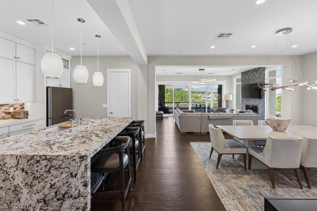 11280 Granite Ridge Drive, #1048, Las Vegas, NV 89135 Gleaming hardwood floors and a spacious open layout flow seamlessly into the light-filled dining space.