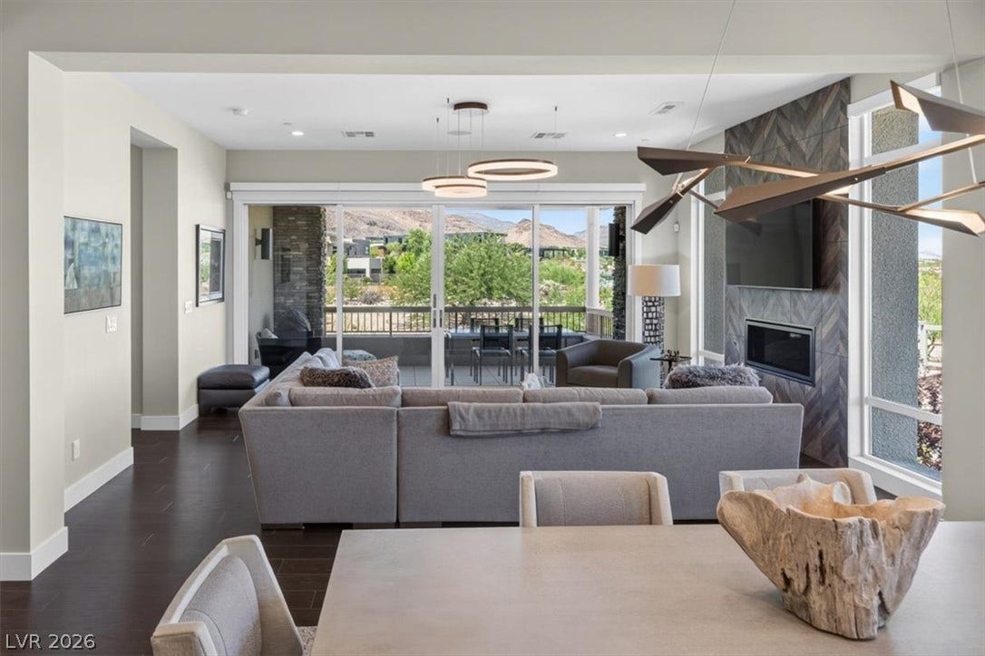 11280 Granite Ridge Drive, #1048, Las Vegas, NV 89135 A modern fireplace acts as a focal point in this open, light-filled living area.