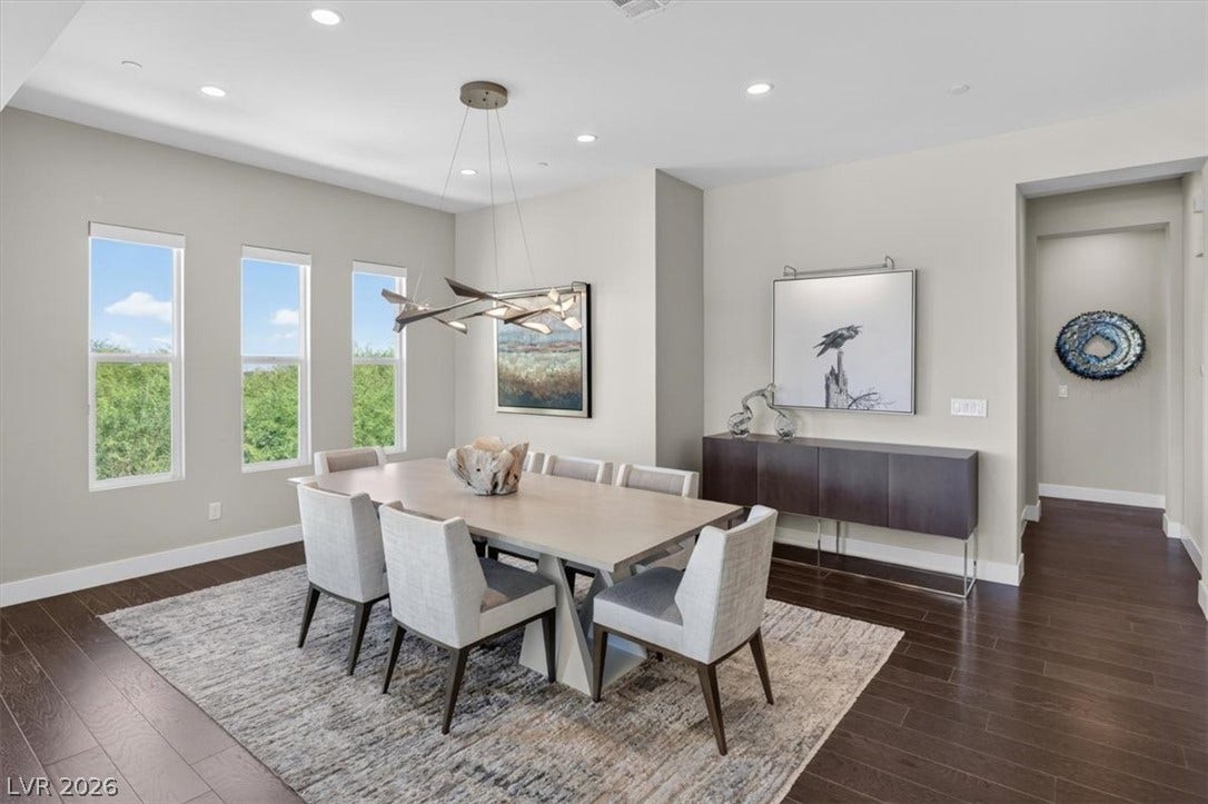 11280 Granite Ridge Drive, #1048, Las Vegas, NV 89135 Rich hardwood floors contrast beautifully with light walls beneath recessed lighting in this dining space.