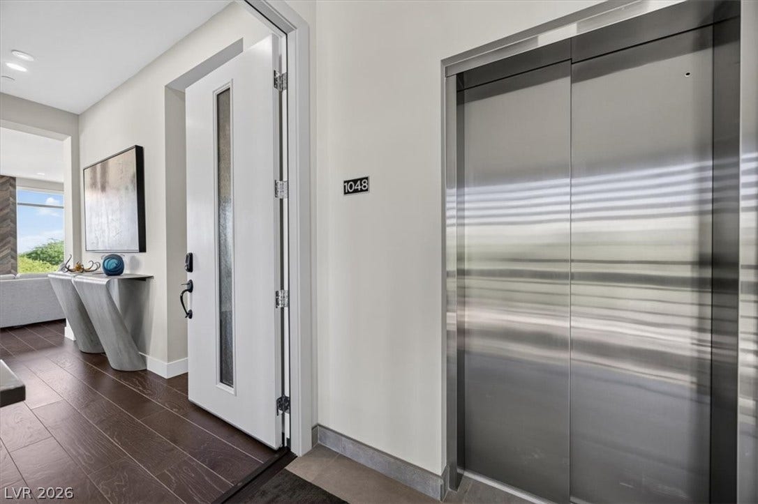 11280 Granite Ridge Drive, #1048, Las Vegas, NV 89135 Rich hardwood flooring leads from the secure private entry to a modern personal elevator.