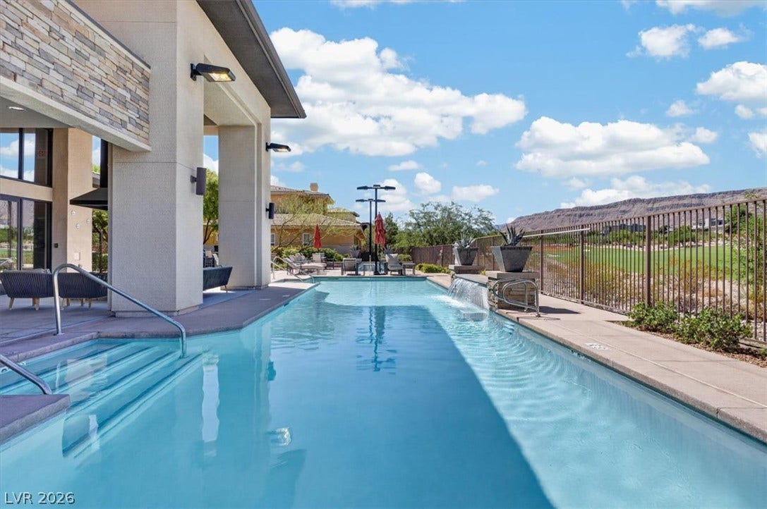11280 Granite Ridge Drive, #1048, Las Vegas, NV 89135 An inviting lap pool features a stone water spillway alongside a covered patio.