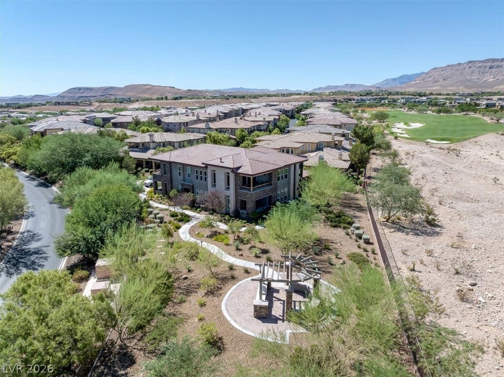 11280 Granite Ridge Drive, #1048, Las Vegas, NV 89135 Desert foothills and a green golf course frame this master-planned community's aerial vista.