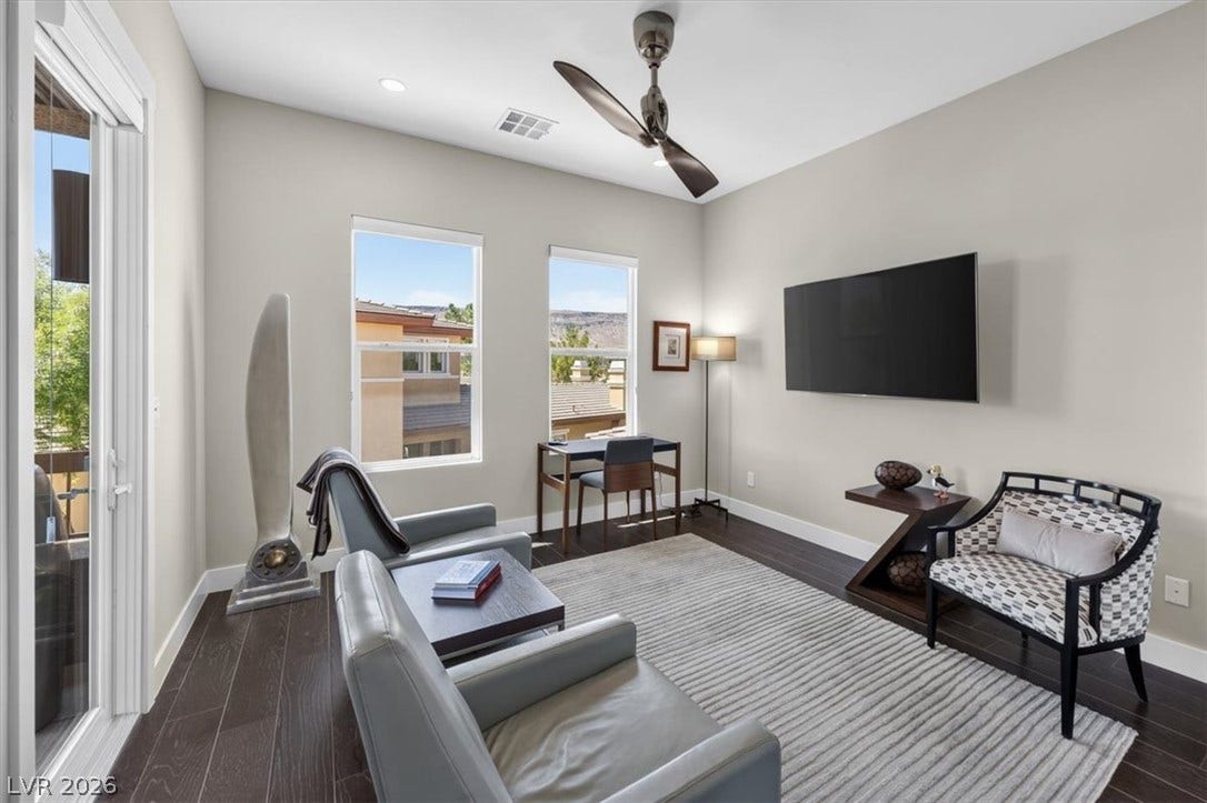 11280 Granite Ridge Drive, #1048, Las Vegas, NV 89135 Gleaming wood floors and a sliding glass door define this light-filled modern living space.