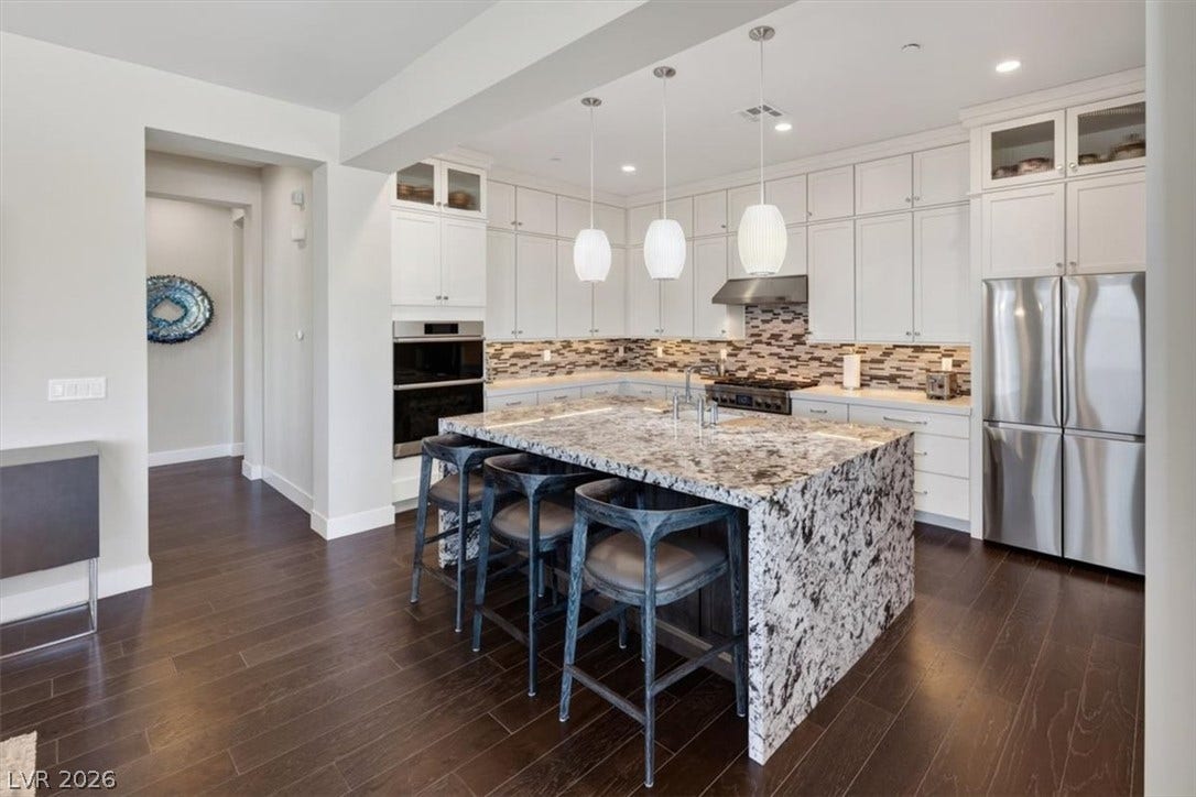 11280 Granite Ridge Drive, #1048, Las Vegas, NV 89135 Gleaming stone countertops and rich hardwood floors define this open culinary space.