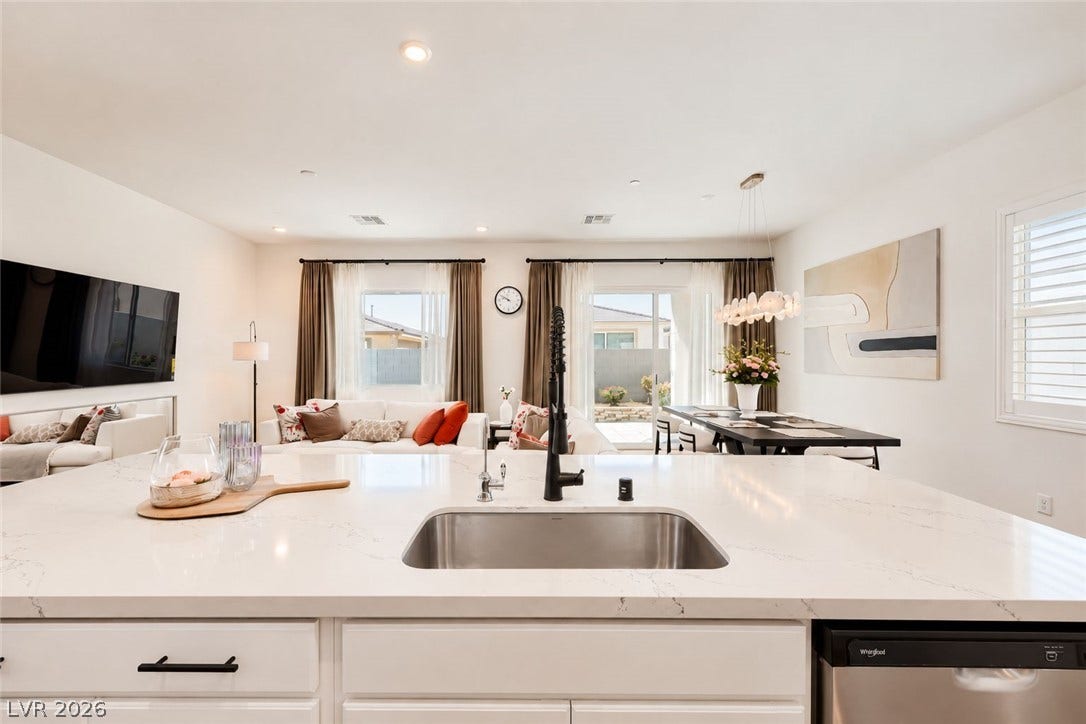 Gleaming stone counters and an open layout connect the kitchen directly to the living space.