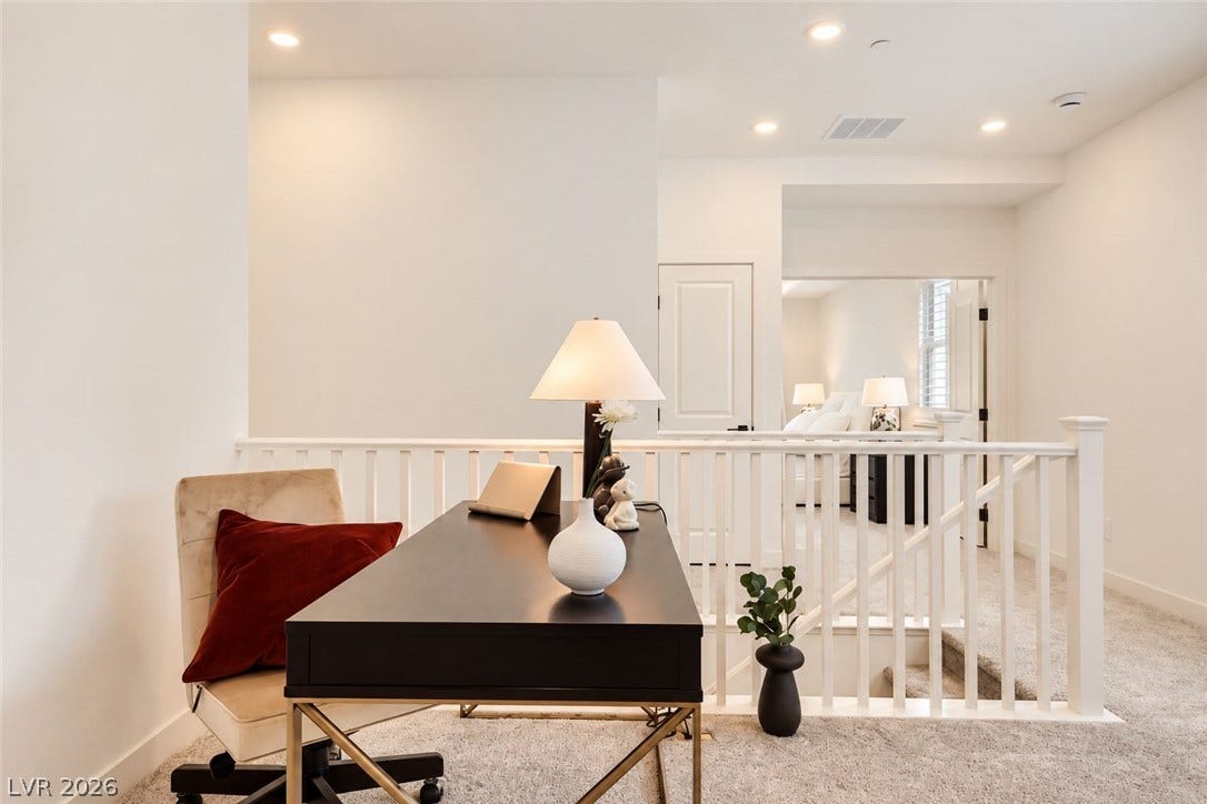 A versatile upper-level loft features wall-to-wall carpeting and recessed lighting.