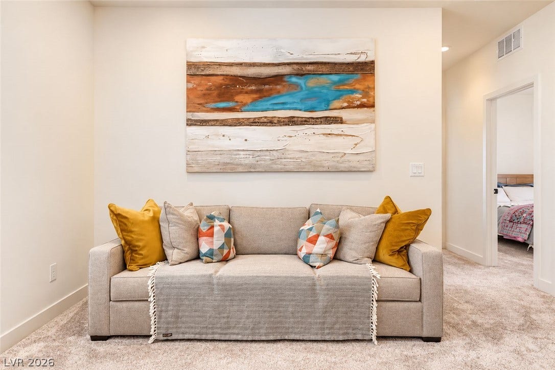 Soft carpeting underfoot defines this inviting, alcove-style common area near the bedrooms.