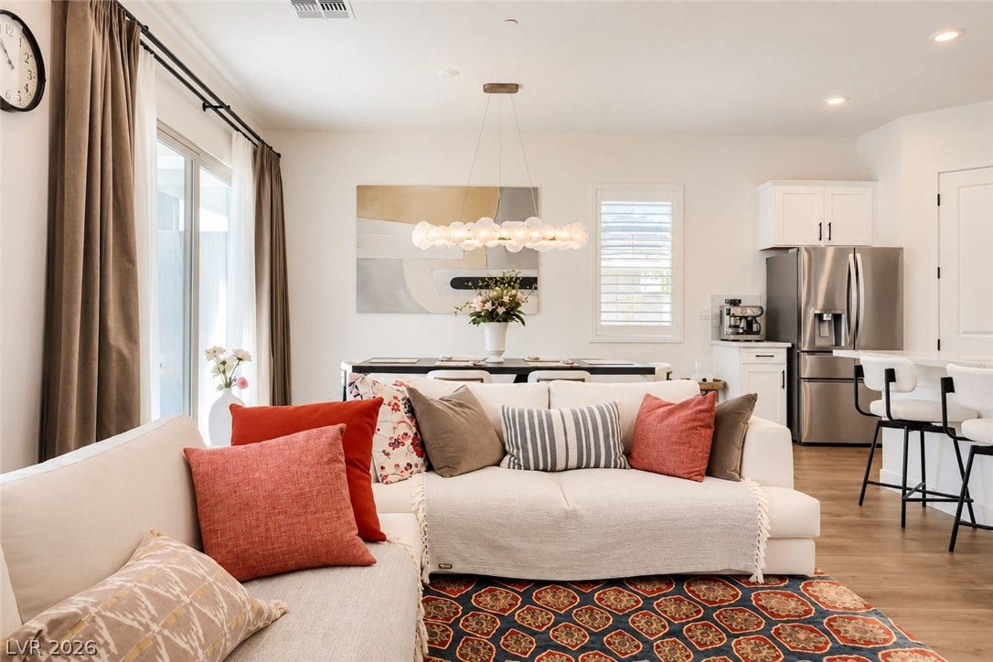 Gleaming hardwood floors and a modern open floorplan connect the main living areas seamlessly.