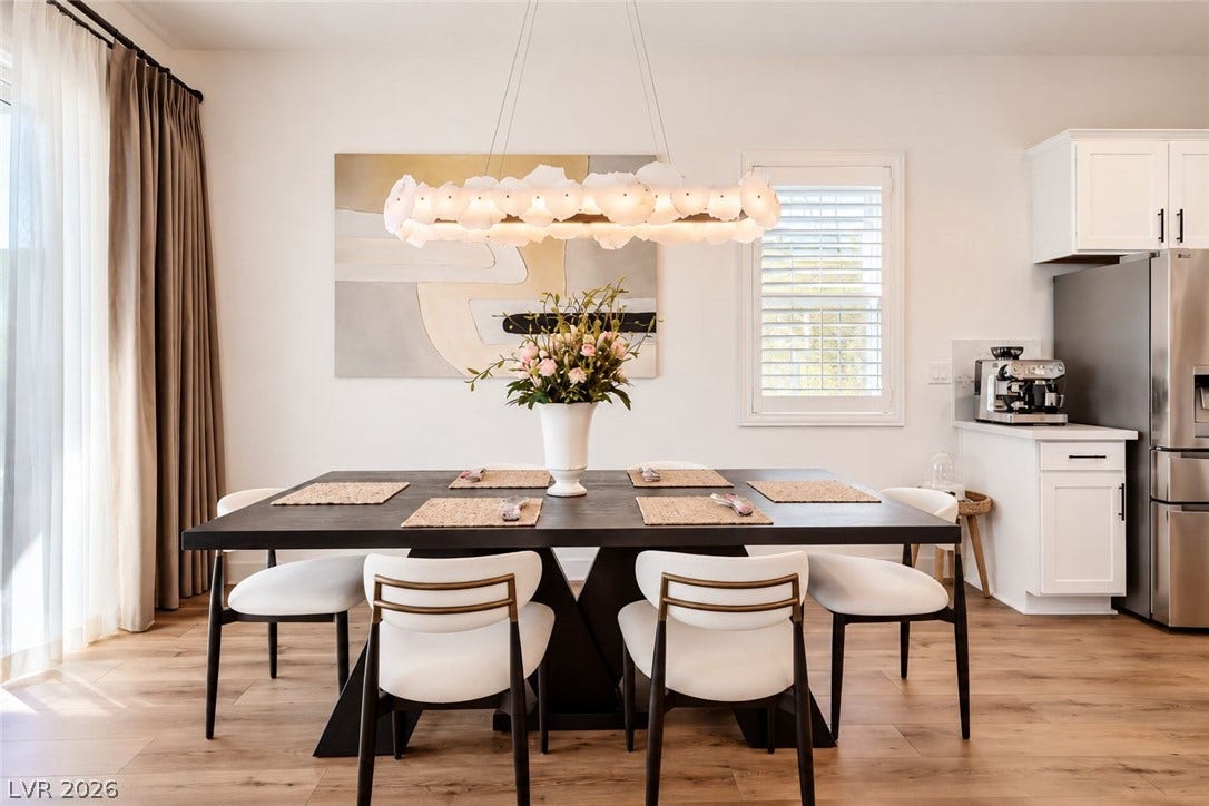 Natural light pours across the warm wood floors in this inviting dining area.