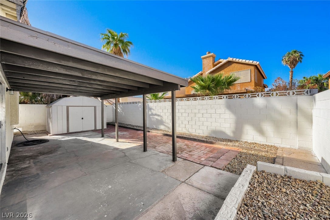 5736 Baffy Circle, Las Vegas, NV 89142 An covered patio overlooks the fenced yard complete with concrete and paver detailing.