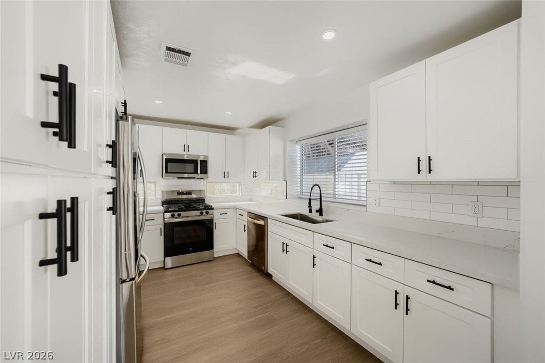 5736 Baffy Circle, Las Vegas, NV 89142 Gleaming stone countertops and modern shaker cabinetry frame this updated culinary space.