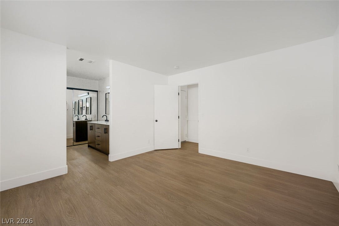 5736 Baffy Circle, Las Vegas, NV 89142 Smooth wood flooring and crisp white walls define this airy master suite with attached bath.
