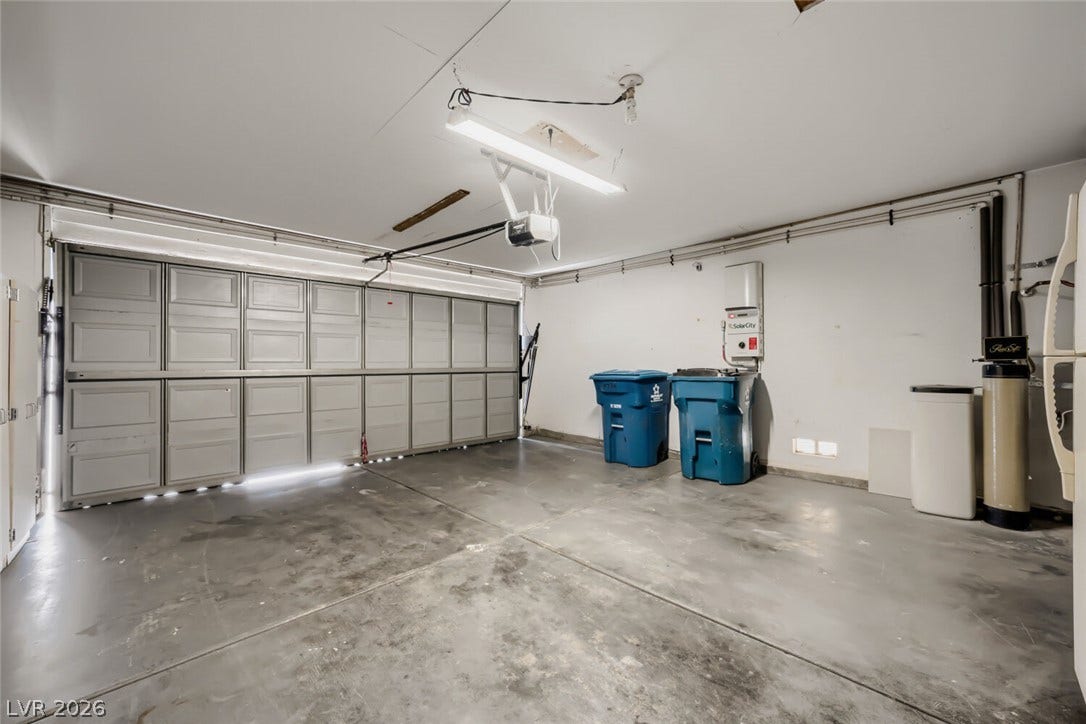 5736 Baffy Circle, Las Vegas, NV 89142 Smooth concrete floors and a wide overhead door define this functional garage space.