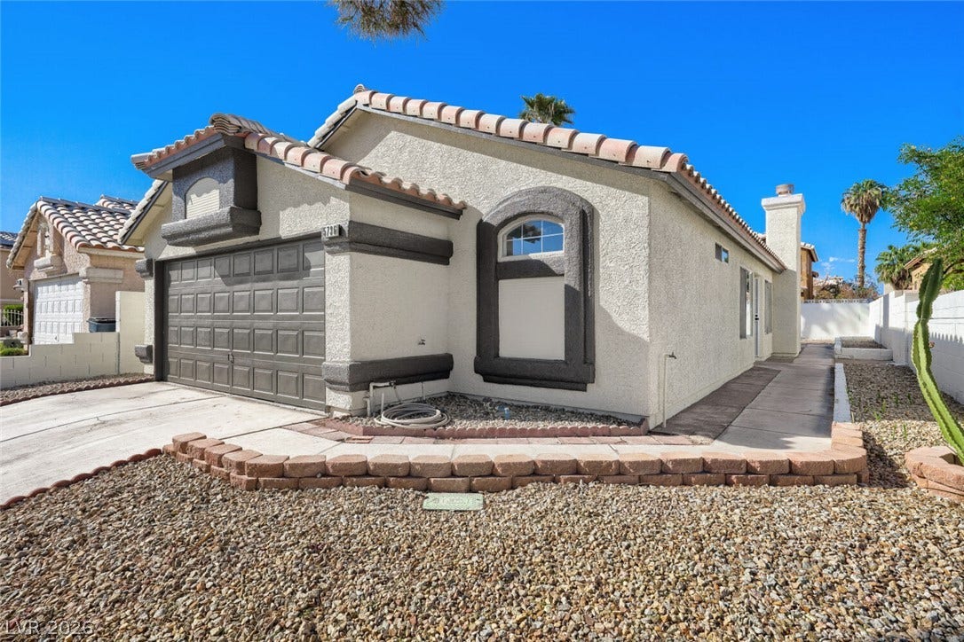 5736 Baffy Circle, Las Vegas, NV 89142 Tiled roofing and a structured stucco exterior define this classic desert-style residence.