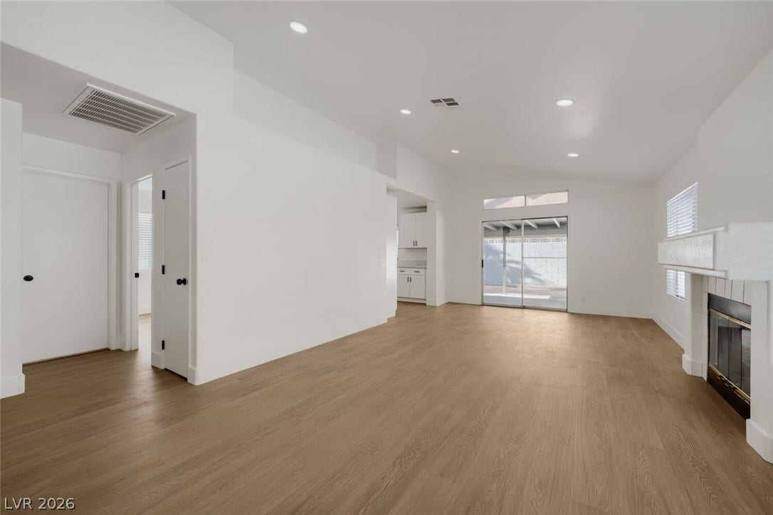 5736 Baffy Circle, Las Vegas, NV 89142 A spacious living area features recessed lighting, durable wood-look flooring, and a classic fireplace.