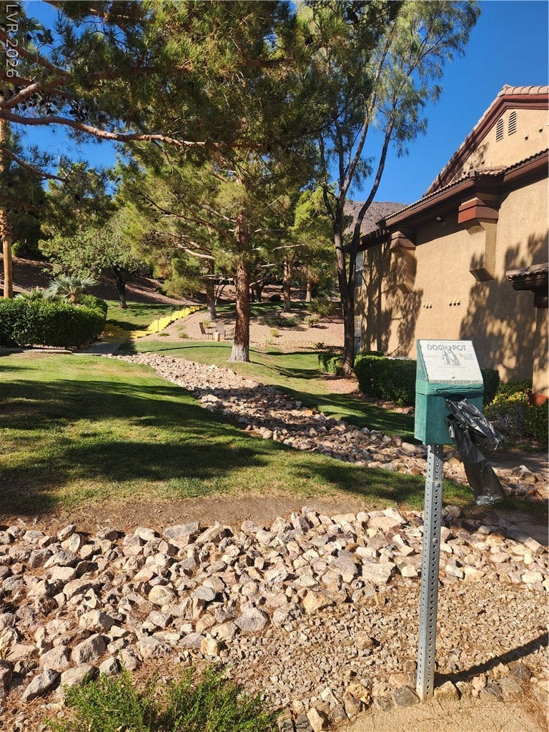 231 W Horizon Ridge Parkway, #924, Henderson, NV 89012 Mature trees and neat rock landscaping accent the grassy common areas of this community.