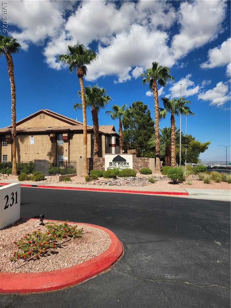 231 W Horizon Ridge Parkway, #924, Henderson, NV 89012 Towering palm trees frame the welcoming entrance path of this residential community.