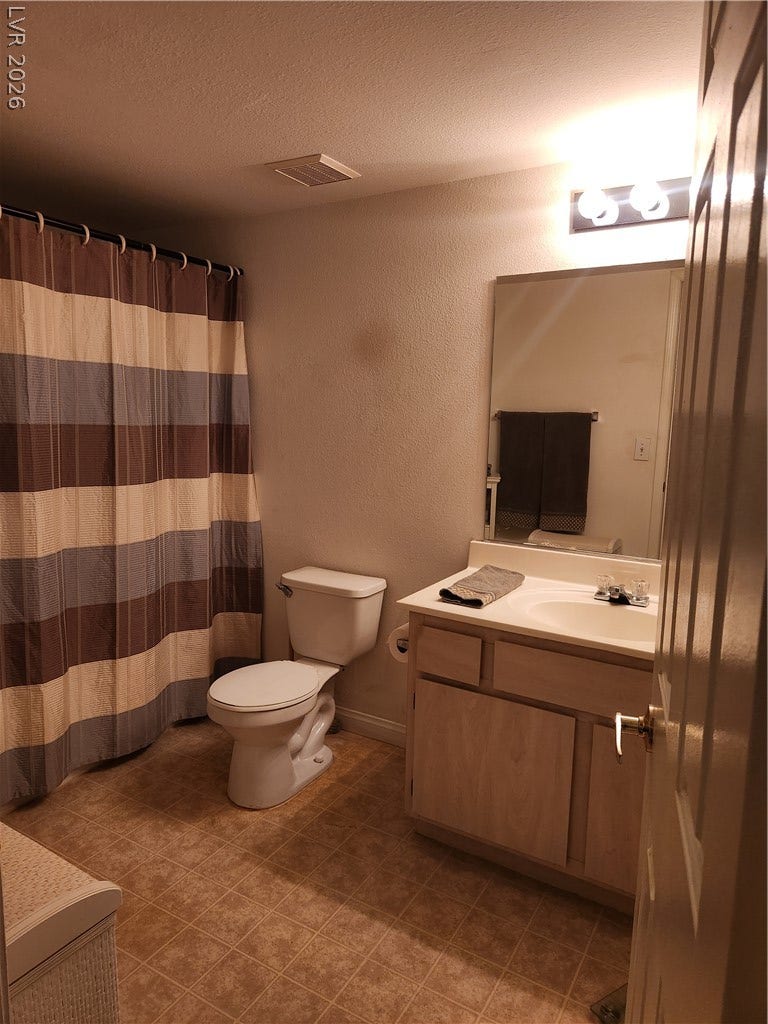 231 W Horizon Ridge Parkway, #924, Henderson, NV 89012 A classic bathroom layout features wood-look cabinetry and neutral vinyl flooring.