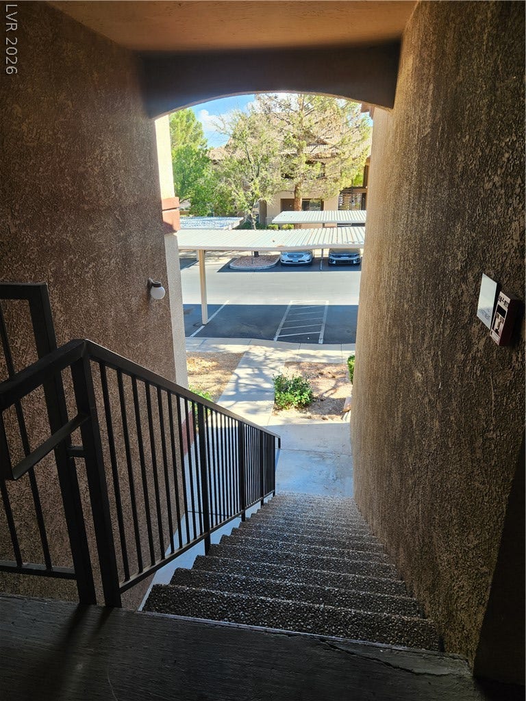 231 W Horizon Ridge Parkway, #924, Henderson, NV 89012 Concrete stairs lead down to a sheltered walkway overlooking the parking area.