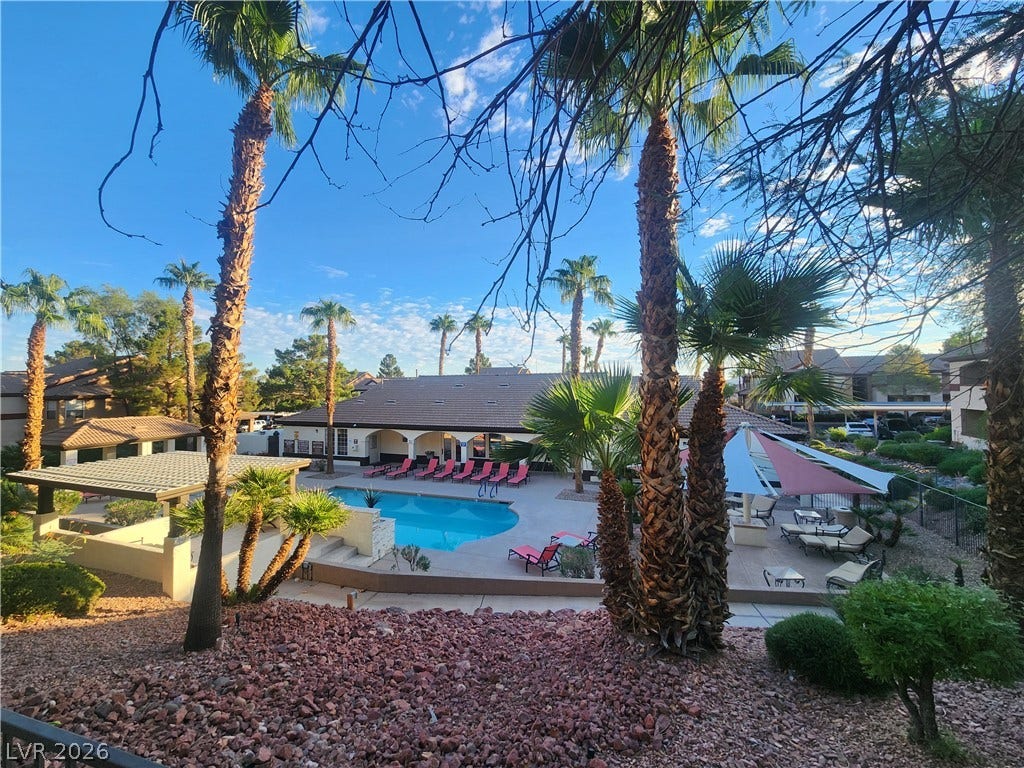 231 W Horizon Ridge Parkway, #924, Henderson, NV 89012 Palm trees frame a sparkling community pool set against clear desert skies.