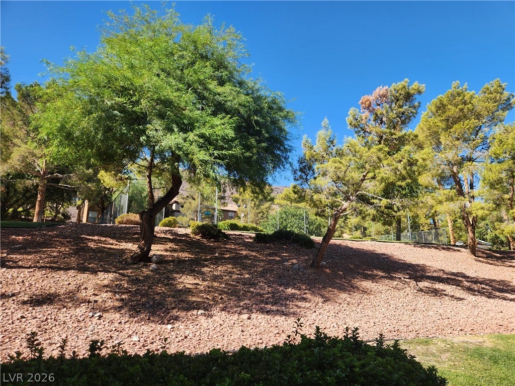 231 W Horizon Ridge Parkway, #924, Henderson, NV 89012 Mature trees shade a gently sloping landscape under a clear blue sky.