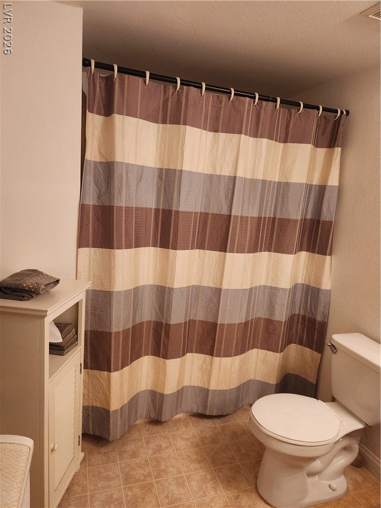 231 W Horizon Ridge Parkway, #924, Henderson, NV 89012 A functional bathroom setup includes durable tile flooring and built-in storage cabinets.
