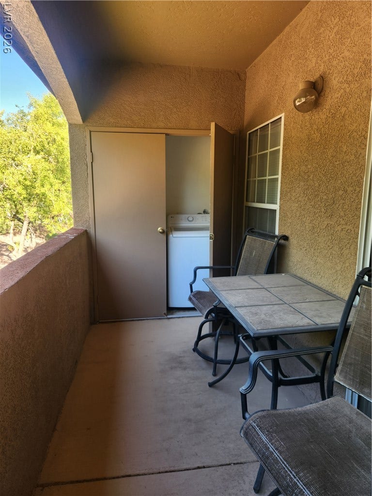 231 W Horizon Ridge Parkway, #924, Henderson, NV 89012 A private covered patio features textured stucco walls and direct access to outdoor laundry storage.