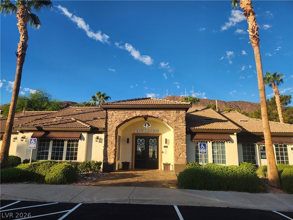 231 W Horizon Ridge Parkway, #924, Henderson, NV 89012 An inviting stone archway frames the entrance to the community clubhouse set against mountain views.
