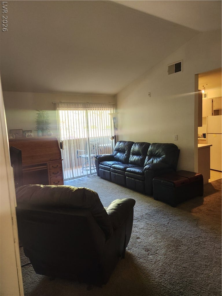 231 W Horizon Ridge Parkway, #924, Henderson, NV 89012 A spacious living area features high vaulted ceilings and a sliding glass door to the outside.