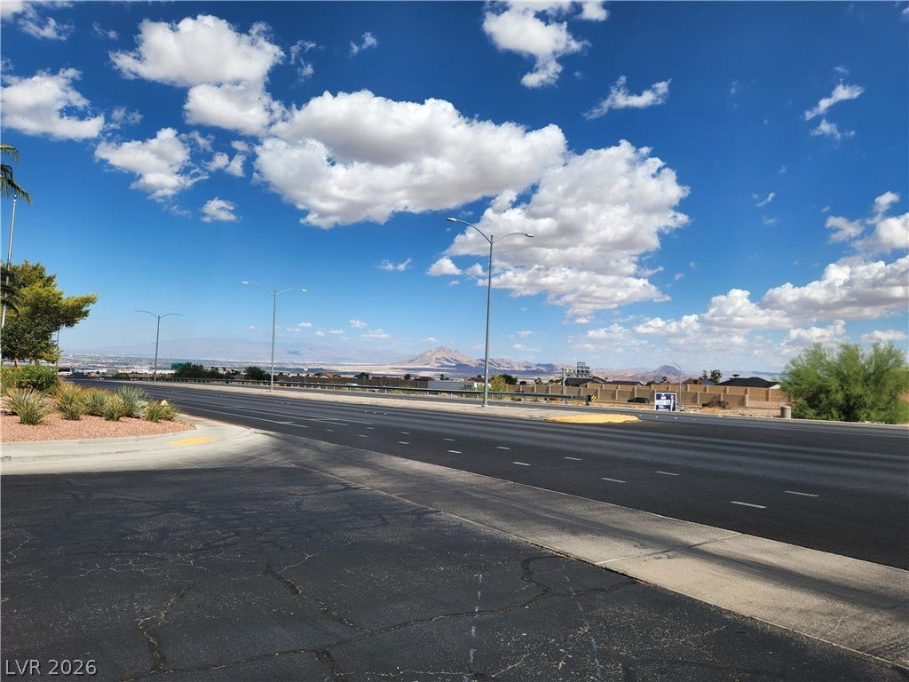 231 W Horizon Ridge Parkway, #924, Henderson, NV 89012 Distant mountains frame the horizon beyond the paved streets and open skies.