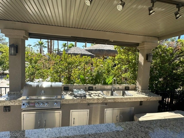 8175 Arville Street, #163, Las Vegas, NV 89139 An outdoor kitchen features granite countertops, integrated stainless steel appliances, and a covered pavilion.
