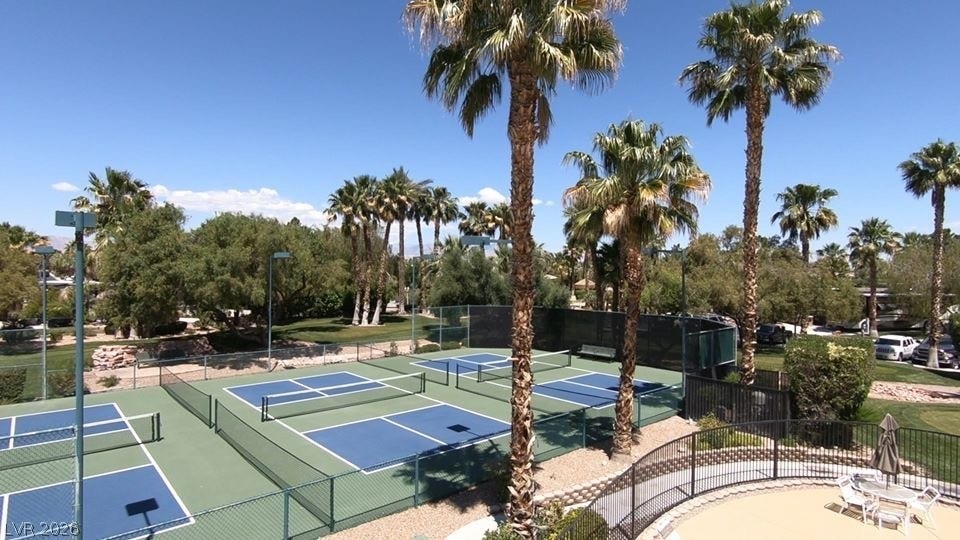 8175 Arville Street, #163, Las Vegas, NV 89139 Lush palm trees frame pristine sports courts under a clear blue desert sky.