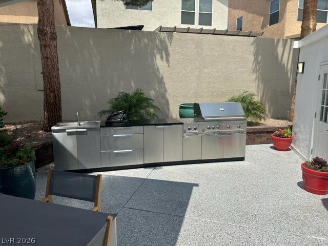 8175 Arville Street, #236, Las Vegas, NV 89139 An outdoor kitchen features premium stainless steel appliances and a matching prep sink.