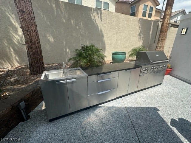 8175 Arville Street, #236, Las Vegas, NV 89139 A sleek outdoor kitchen with stainless steel cabinetry and a built-in grill highlights this patio.