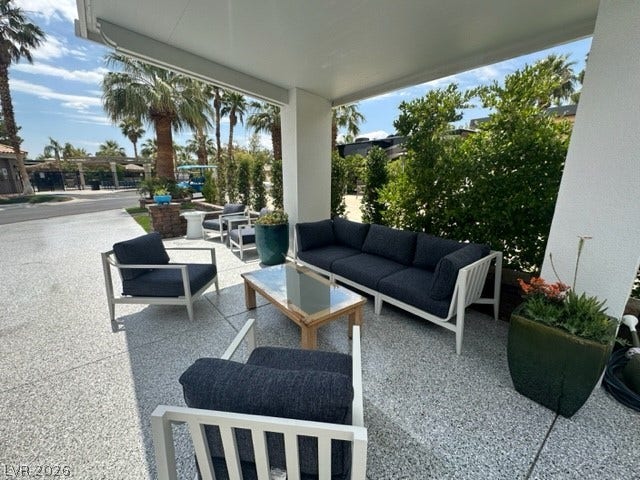 8175 Arville Street, #236, Las Vegas, NV 89139 A shaded outdoor lounge area features durable aggregate flooring beneath a protective solid roof.