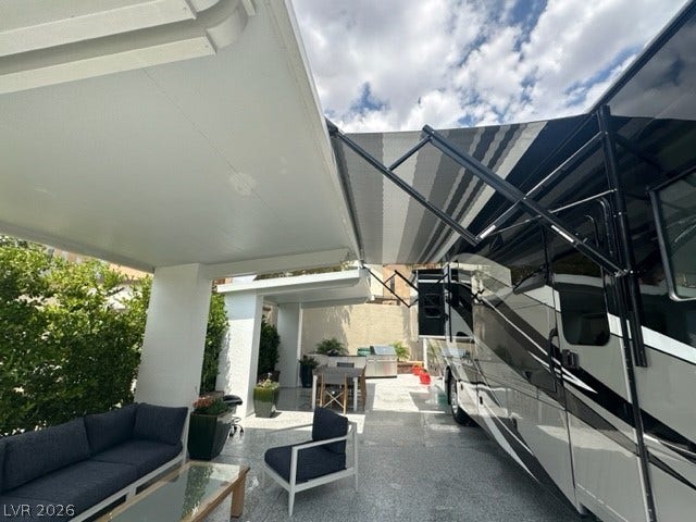 8175 Arville Street, #236, Las Vegas, NV 89139 Sheltered outdoor spaces alongside a dedicated vehicle pad offer seamless indoor-outdoor utility.