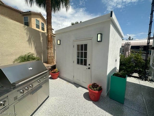8175 Arville Street, #236, Las Vegas, NV 89139 Detached accessory structure sits adjacent to a built-in outdoor grilling station on concrete flooring.