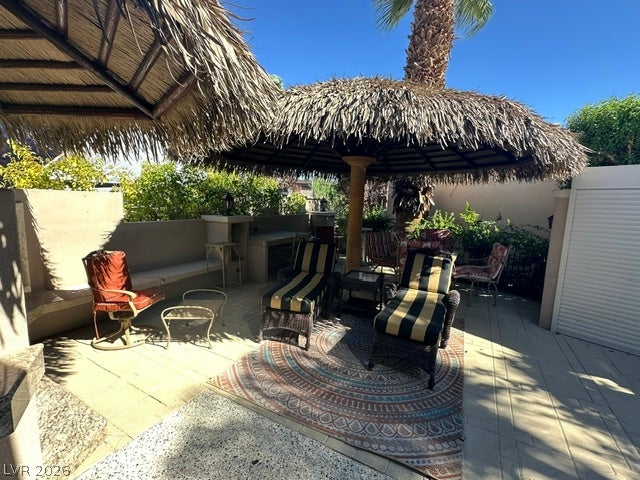 8175 Arville Street, #266, Las Vegas, NV 89139 Thatched palapas provide cool shade over a stone-paved patio surrounded by privacy walls.