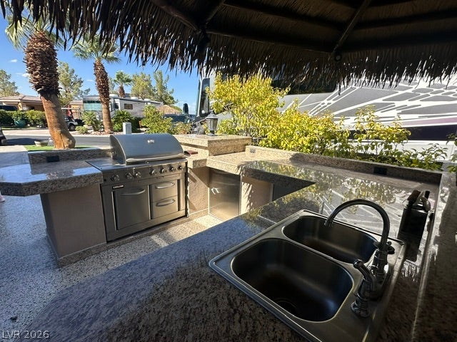 8175 Arville Street, #266, Las Vegas, NV 89139 Granite countertops and a built-in stainless steel grill define this functional outdoor kitchen space.