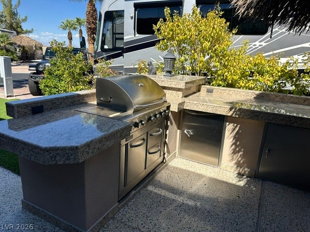 8175 Arville Street, #266, Las Vegas, NV 89139 An outdoor kitchen features durable stone countertops alongside a built-in stainless steel grill.