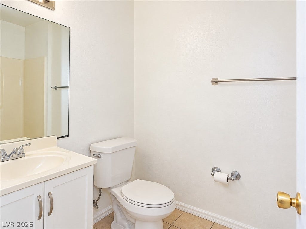 Clean lines and neutral tile flooring define this functional bathroom space.