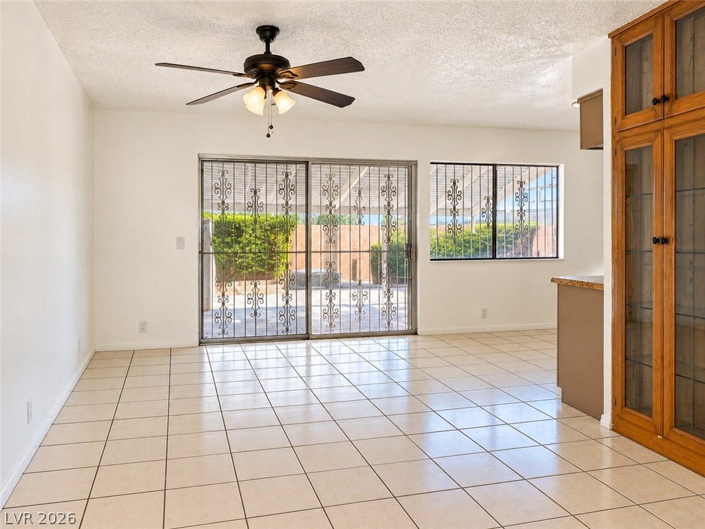 Tiled flooring and sliding doors opening to the patio define this versatile dining area.