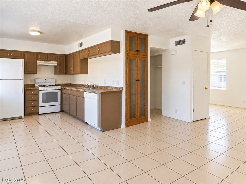 Ample cabinetry and tile flooring define this functional open-concept culinary space.