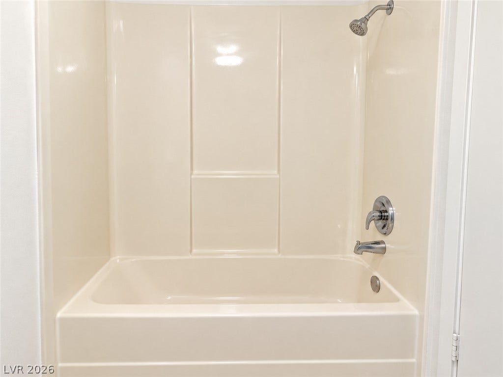 A classic shower and tub combination features clean lines and chrome fixtures.
