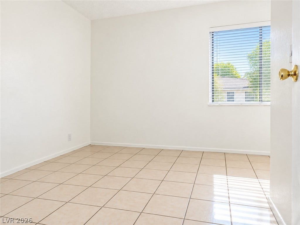 Tiled flooring and a large window define this versatile interior space.