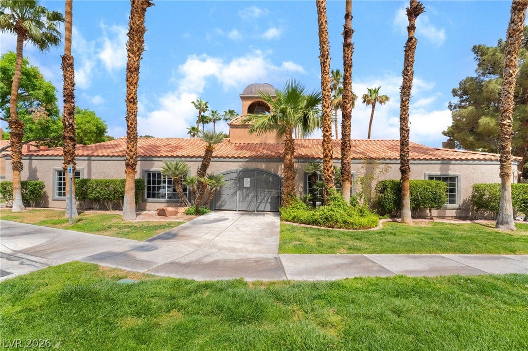 230 Mission Catalina Lane, #202, Las Vegas, NV 89107 Spanish tile roofing and towering palm trees frame this elegant stucco exterior.