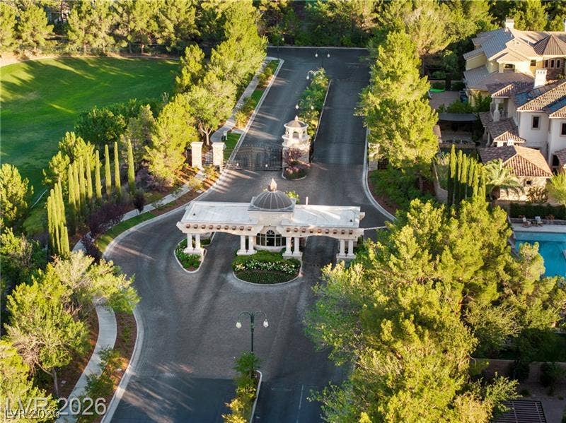A secure gated entrance welcomes residents to this exclusive community surrounded by lush greenery.