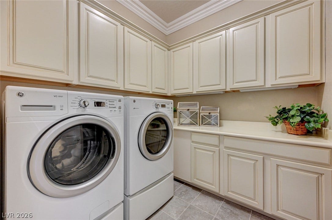 Crown molding and matching cabinetry elevate this functional utility space.