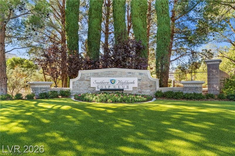 Mature trees frame the stone monument sign greeting residents of this premier golf community.